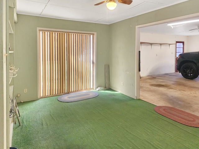 interior space with a ceiling fan and carpet flooring