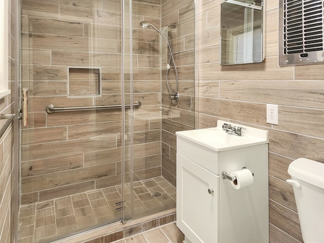 full bathroom with toilet, a stall shower, and vanity