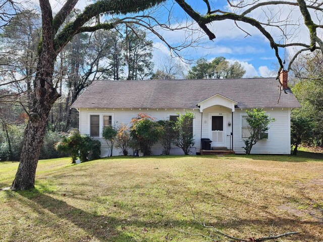 512 Tenaha St, Center, TX 75935 - view of front of property featuring a chimney, a front yard, and a shingled roof