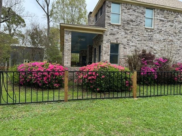 445 Riverbend Dr, Hemphill, TX 75948 - exterior space featuring brick siding, fence private yard, and a lawn