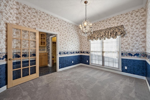 445 Riverbend Dr, Hemphill, TX 75948 - carpeted empty room with a wainscoted wall, a chandelier, baseboards, wallpapered walls, and ornamental molding
