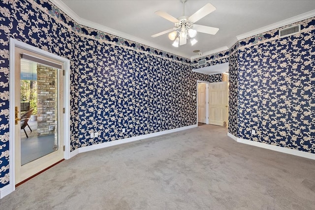 carpeted spare room with ceiling fan and crown molding