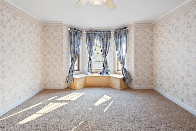 spare room featuring ceiling fan, carpet, and ornamental molding