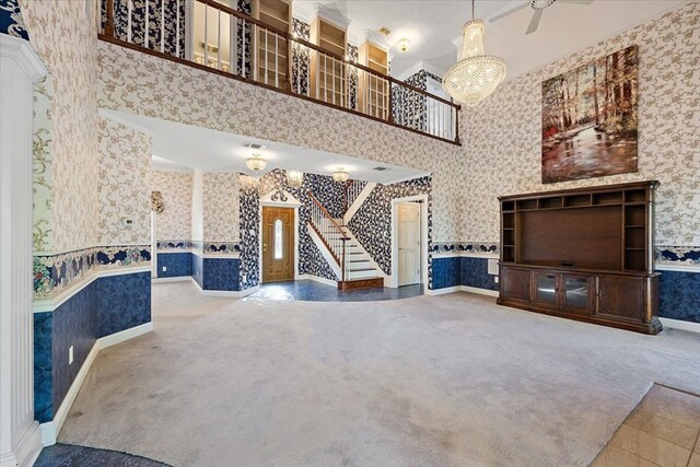 445 Riverbend Dr, Hemphill, TX 75948 - unfurnished living room with carpet flooring, wallpapered walls, an inviting chandelier, and a high ceiling