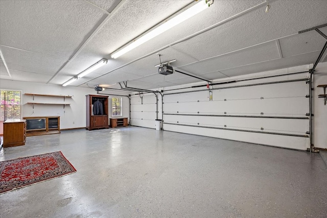 445 Riverbend Dr, Hemphill, TX 75948 - garage with baseboards and a garage door opener