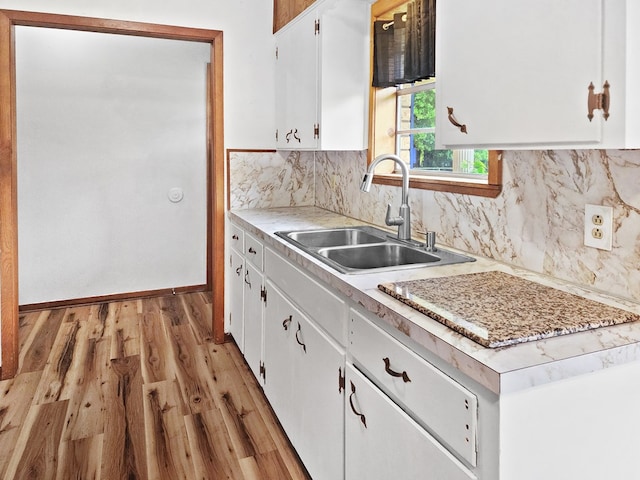 4296 US Highway 190 W, Jasper, TX 75951 - kitchen featuring a sink, light countertops, white cabinetry, light wood finished floors, and tasteful backsplash
