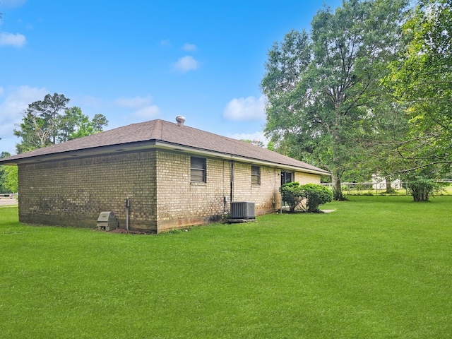 4296 US Highway 190 W, Jasper, TX 75951 - view of home's exterior with cooling unit, a lawn, and brick siding