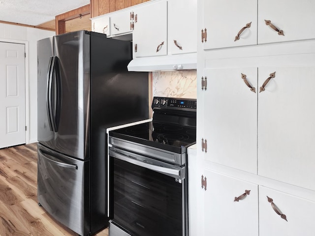4296 US Highway 190 W, Jasper, TX 75951 - kitchen with stainless steel appliances, under cabinet range hood, light wood finished floors, white cabinets, and backsplash