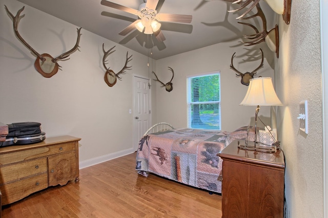 bedroom with ceiling fan and light hardwood / wood-style flooring