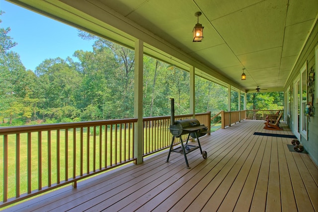 deck with a porch and a yard