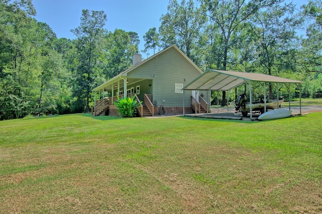 back of property featuring a carport and a yard