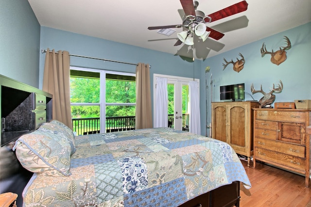 bedroom with access to exterior, ceiling fan, and wood-type flooring