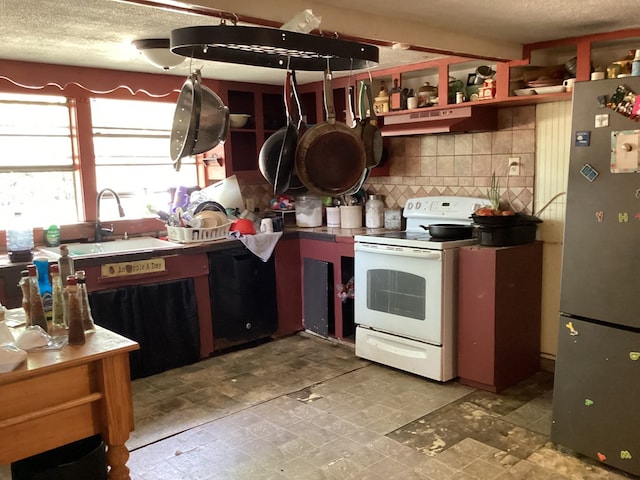 1734 Fm 82 W, Kirbyville, TX 75956 - kitchen with white electric range oven, freestanding refrigerator, open shelves, a sink, and decorative backsplash