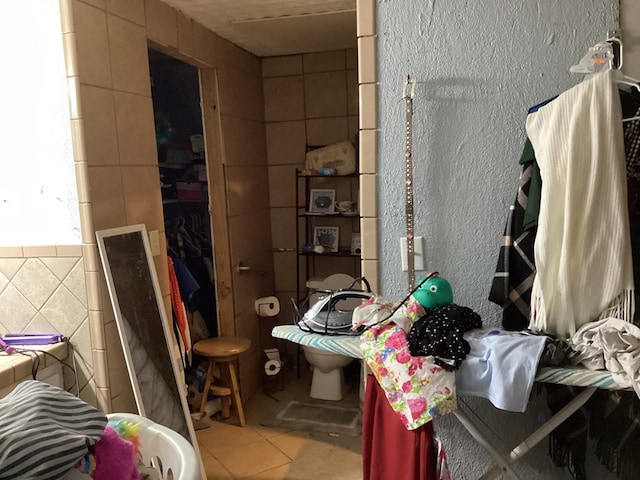 1734 Fm 82 W, Kirbyville, TX 75956 - bathroom featuring tile walls and tile patterned flooring