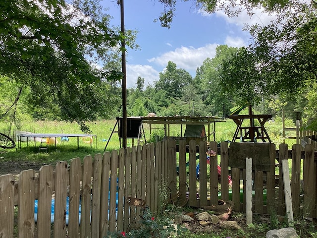 1734 Fm 82 W, Kirbyville, TX 75956 - view of play area with a trampoline and fence