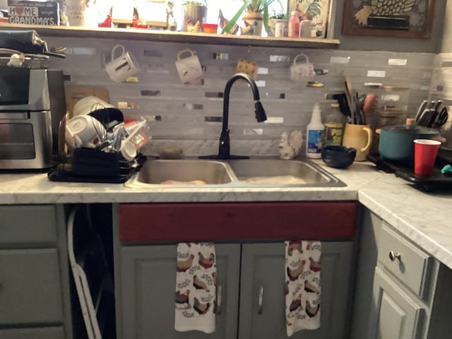 1734 Fm 82 W, Kirbyville, TX 75956 - kitchen with a sink, backsplash, and light countertops