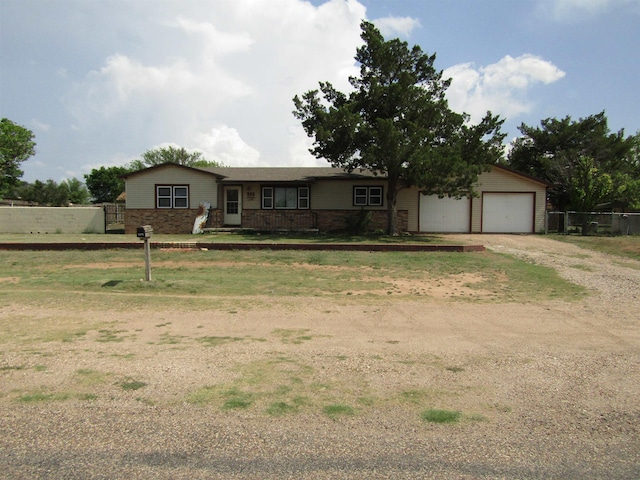 ranch-style home featuring a front yard and a garage