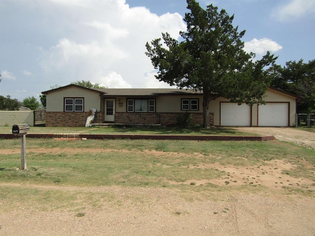 single story home with a garage and a front lawn