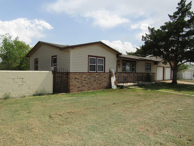 view of front of property featuring a garage and a front lawn