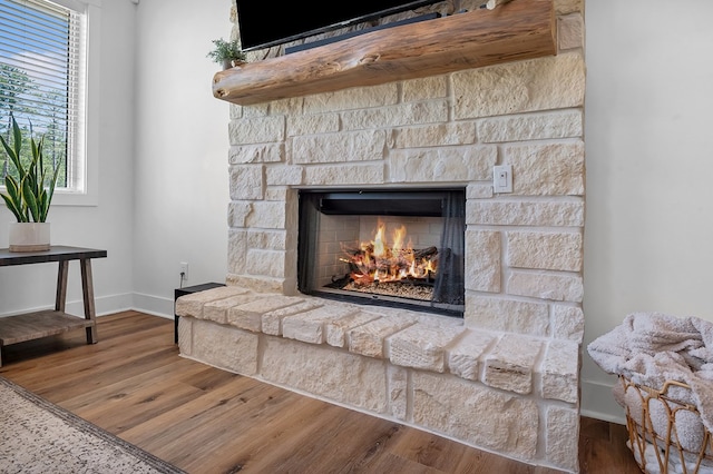150 Tatanka Trl, Brookeland, TX 75931 - detailed view of a stone fireplace, baseboards, and wood finished floors