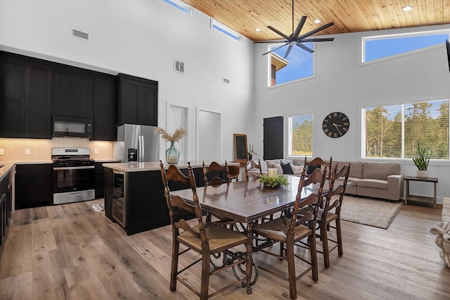 150 Tatanka Trl, Brookeland, TX 75931 - dining room featuring a towering ceiling, wooden ceiling, light wood-style floors, ceiling fan, and recessed lighting
