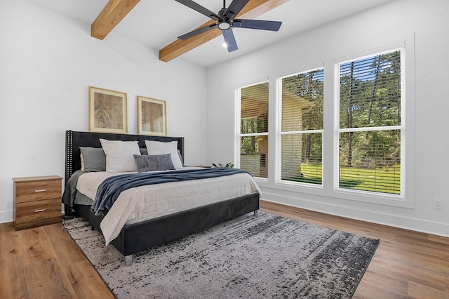 150 Tatanka Trl, Brookeland, TX 75931 - bedroom featuring wood finished floors, baseboards, beamed ceiling, and ceiling fan