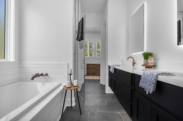 150 Tatanka Trl, Brookeland, TX 75931 - bathroom featuring vanity, a bath, tile patterned floors, and a stall shower
