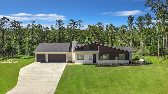 150 Tatanka Trl, Brookeland, TX 75931 - mid-century home featuring a garage, driveway, and a forest view