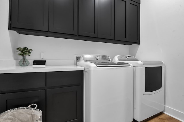 150 Tatanka Trl, Brookeland, TX 75931 - laundry room with cabinet space, independent washer and dryer, baseboards, and light wood-type flooring