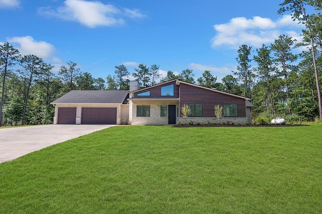 150 Tatanka Trl, Brookeland, TX 75931 - mid-century modern home with a chimney, driveway, a garage, stone siding, and a front yard