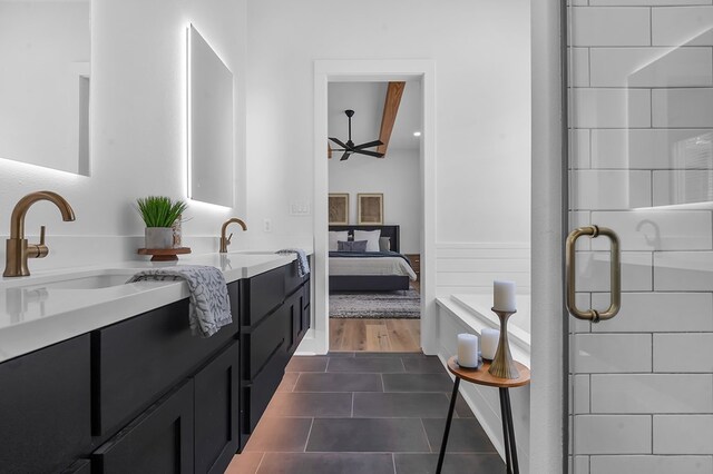 150 Tatanka Trl, Brookeland, TX 75931 - bathroom with double vanity, ensuite bath, tile patterned flooring, wainscoting, and a shower with shower door