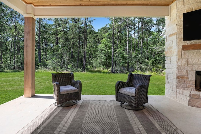150 Tatanka Trl, Brookeland, TX 75931 - view of patio / terrace with an outdoor stone fireplace