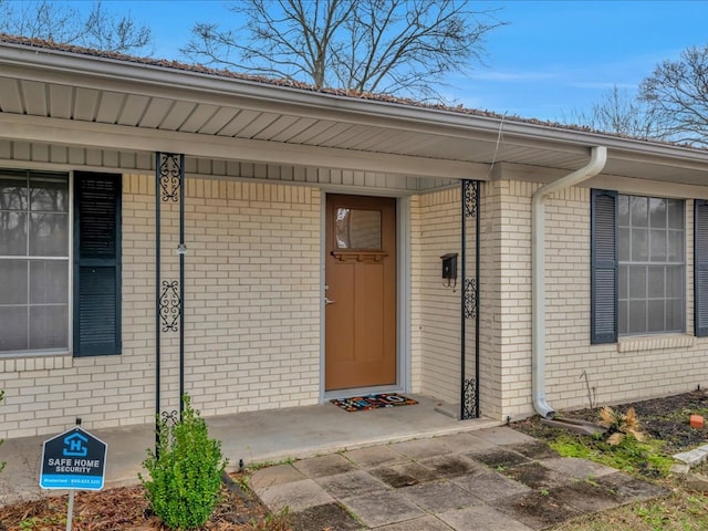 property entrance with brick siding