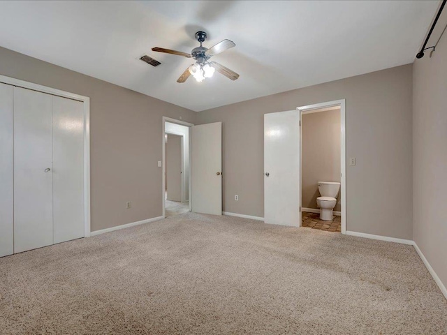 unfurnished bedroom featuring a closet, carpet, visible vents, and baseboards