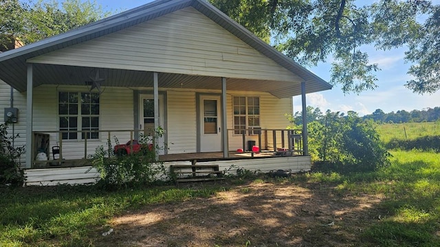 back of property featuring covered porch