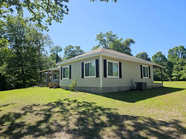 view of home's exterior with central AC unit and a lawn