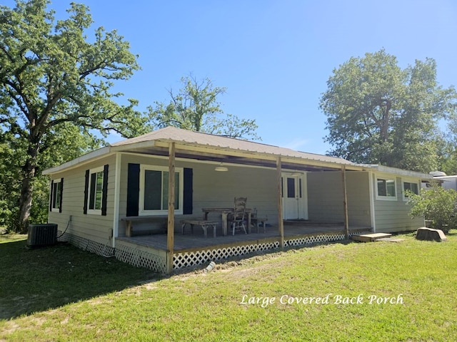 back of house featuring a yard and cooling unit
