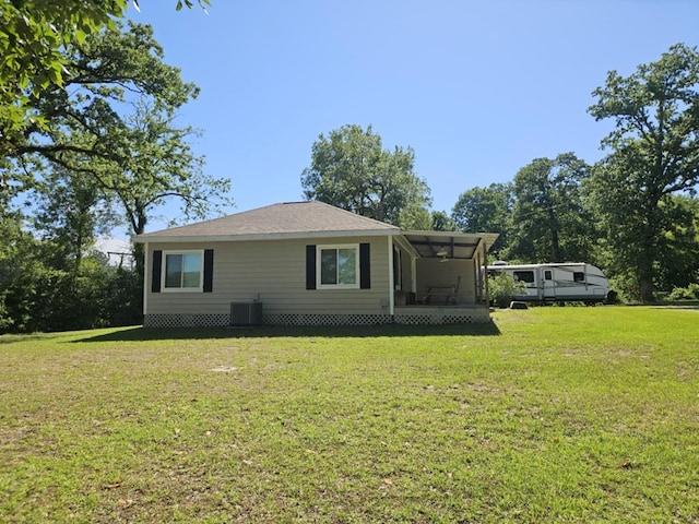 exterior space with a lawn and central AC