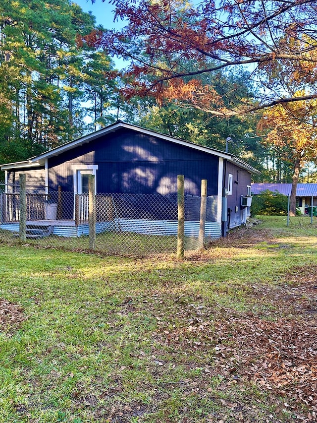 view of side of property with a yard