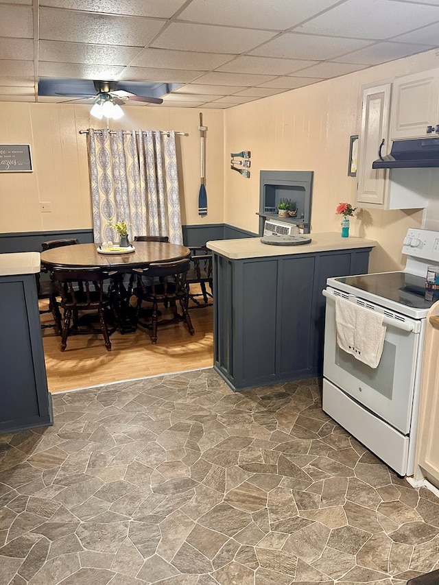 kitchen with a paneled ceiling, white cabinets, electric stove, ceiling fan, and dark hardwood / wood-style flooring