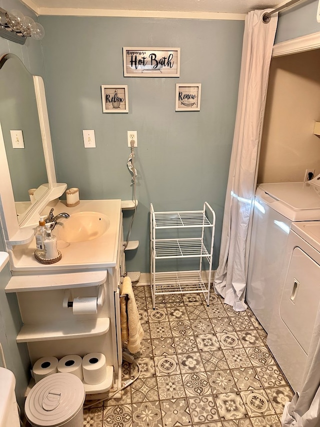 bathroom featuring tile patterned flooring, vanity, and independent washer and dryer