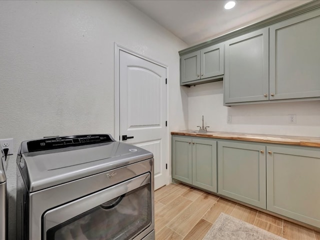 washroom with sink and cabinets