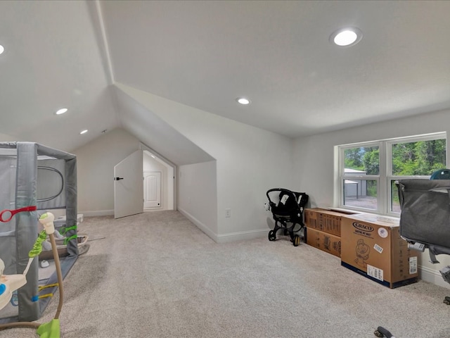 carpeted office space featuring lofted ceiling