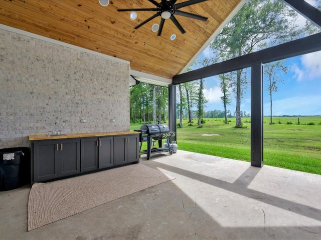 view of patio / terrace with grilling area, ceiling fan, and sink