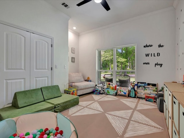 rec room featuring ceiling fan and crown molding