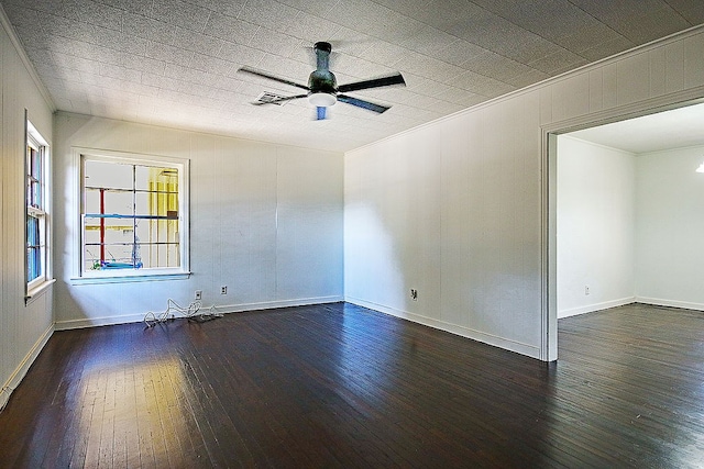 empty room featuring ornamental molding, ceiling fan, and dark wood-type flooring