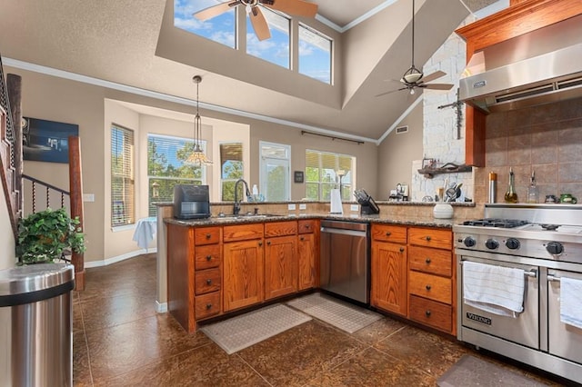 474 Mountain View Rd, Lufkin, TX 74904 - kitchen featuring appliances with stainless steel finishes, ceiling fan, wall chimney range hood, a sink, and crown molding