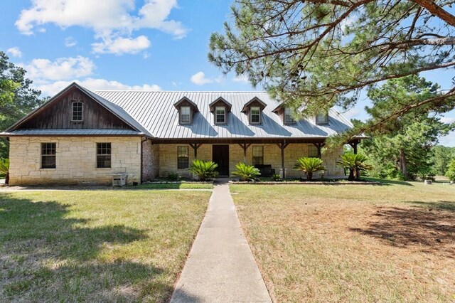 474 Mountain View Rd, Lufkin, TX 74904 - view of front of house with stone siding, a front yard, and metal roof