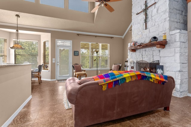 474 Mountain View Rd, Lufkin, TX 74904 - living area featuring baseboards, ceiling fan, a stone fireplace, high vaulted ceiling, and crown molding