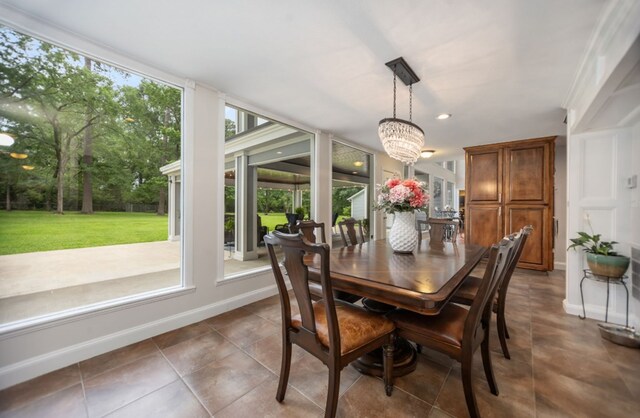 dining space featuring dark tile patterned flooring, baseboards, recessed lighting, and a notable chandelier